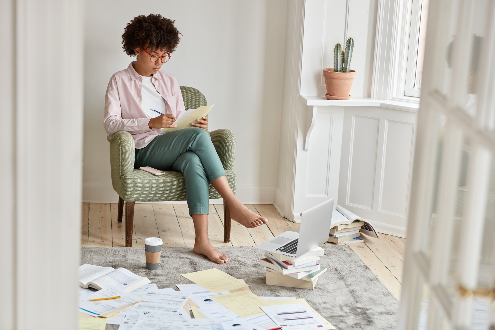 Image of attractive black entrepreneur studies private financing, has disorder in room, involved in